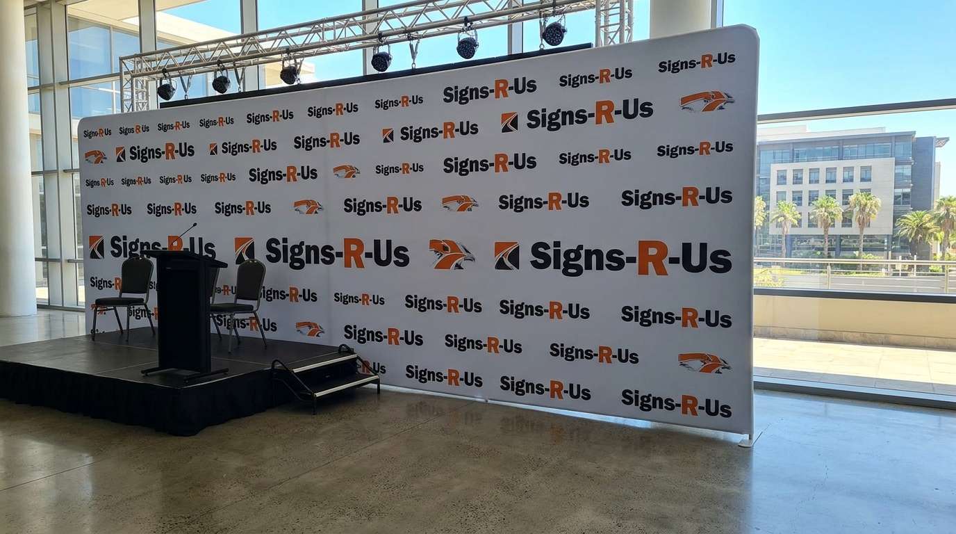 Large printed backdrop panel set up behind a corporate conference stage in South Africa